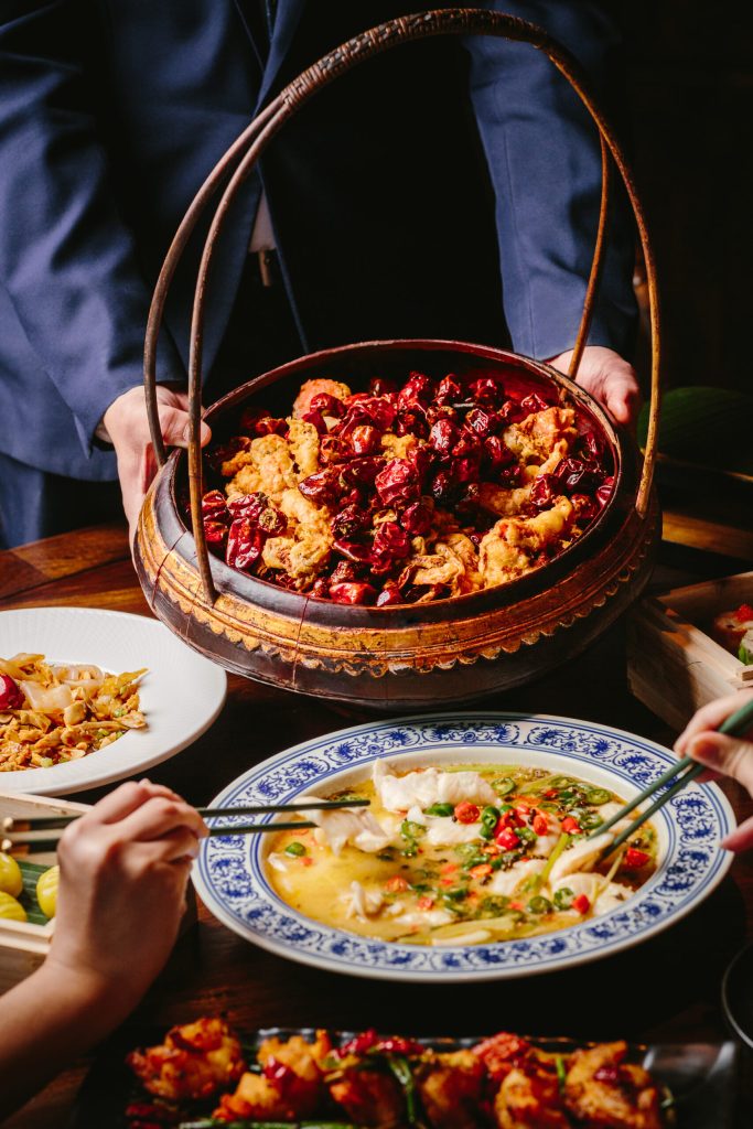 People sharing food in assorted dishes