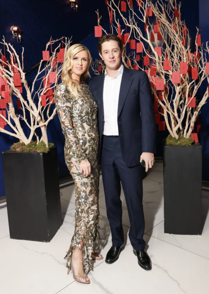 two well dressed people standing together